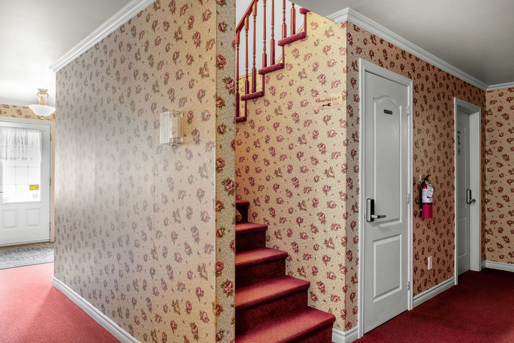 Hallway and staircase in the guest room building at Auberge du Manoir