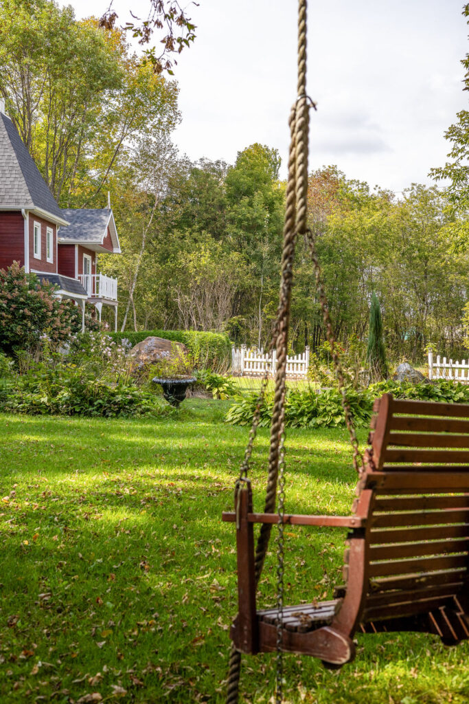 Wooden swing in the garden at Auberge du Manoir