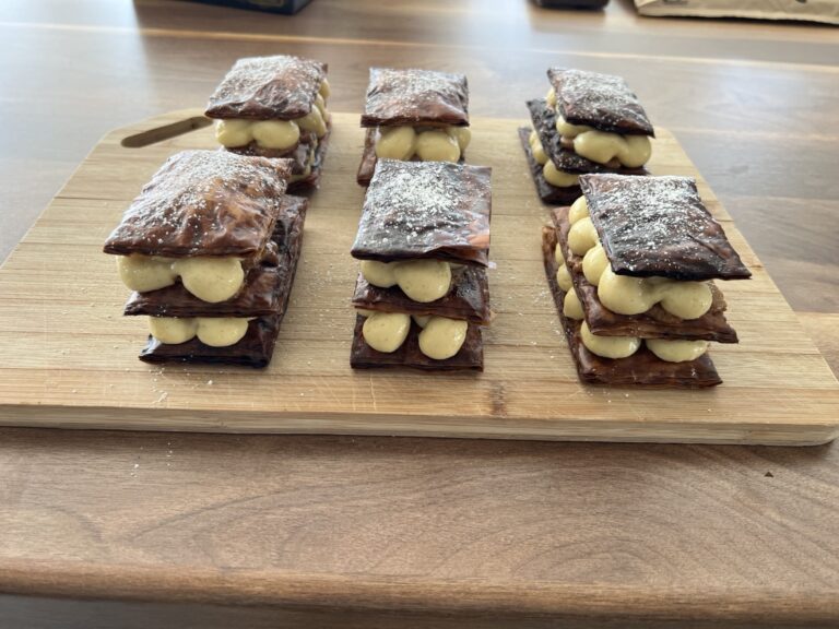Mille-feuille pastries arranged on a serving board.